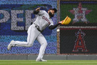 Cleveland Guardians left fielder Amed Rosario can't make the play on this fly by Kansas City Royals' Hunter Dozier during the fifth inning of a baseball game, Thursday, April 7, 2022 in Kansas City, Mo. (AP Photo/Reed Hoffmann)