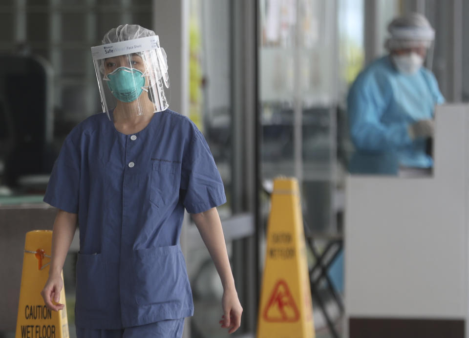 Hospital staff wear face protection at the Princess Margaret Hospital in Hong Kong, Saturday, Feb, 1, 2020. China’s death toll from a new virus continues to rise as a World Health Organization official says other governments need to prepare for“domestic outbreak control” if the disease spreads. (AP Photo/Achmad Ibrahim)