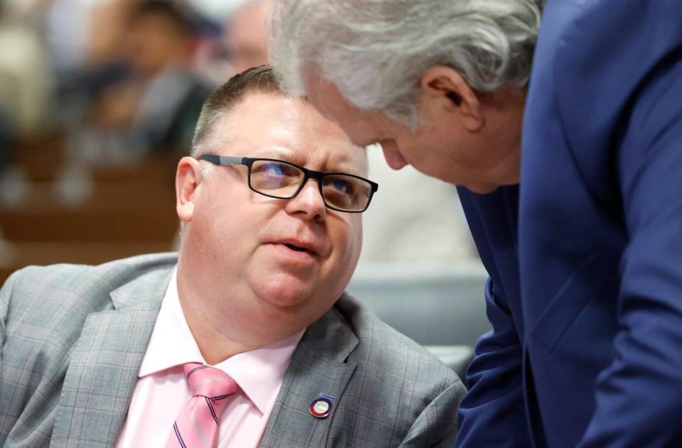 Rep. Jason Saine, left, talks with Rep. John Torbett during the N.C. House session in Raleigh, N.C., Wednesday, June 21, 2023.