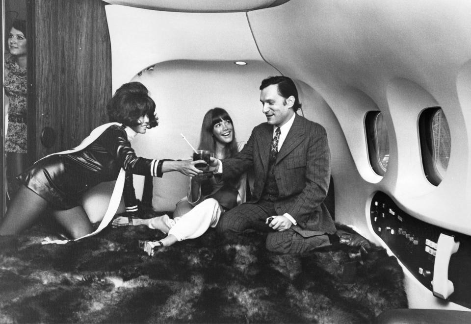 <p>Hugh Hefner and his girlfriend Barbi Benton aboard Hefner's private jet, "The Big Bunny," in 1970. </p>