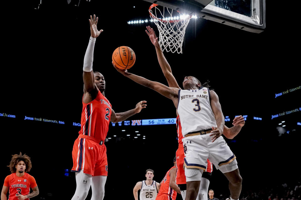 Notre Dame guard Markus Burton (3) attempts a shot against Auburn forward Jaylin Williams (2) during the second half of an NCAA college basketball game in the Legends Classic tournament in New York, Thursday, Nov. 16, 2023. (AP Photo/Peter K. Afriyie)