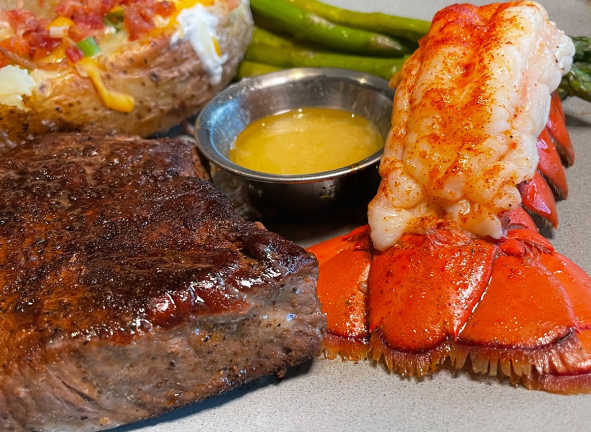 Steak&lobster, served with a stuffed potato and green beans, at Outback Steakhouse