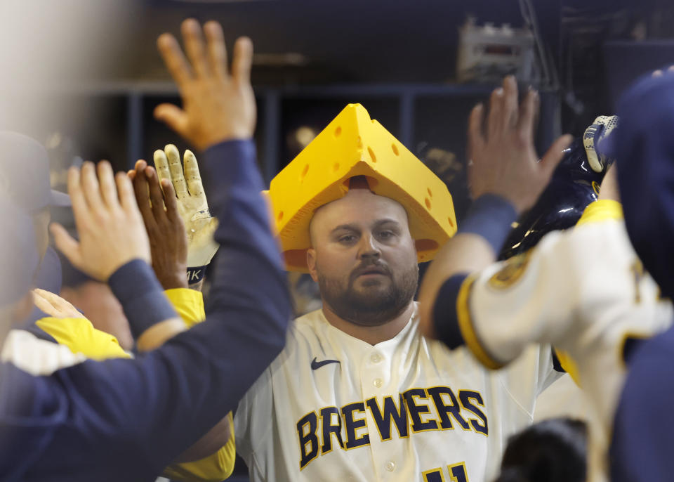 Milwaukee Brewers' Rowdy Tellez celebrates in the dugout after his home run against the Detroit Tigers during the sixth inning of a baseball game Tuesday, April 25, 2023, in Milwaukee. (AP Photo/Jeffrey Phelps)