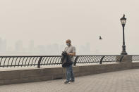 <p>A man walks wearing a mask as an air quality health advisory was issued in New York on Wednesday, June 7, 2023. (AP Photo/Andres Kudacki).</p> 