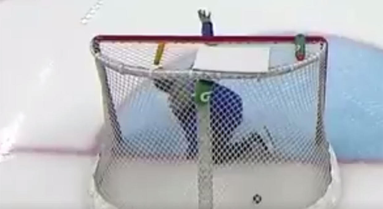 A member of the ice crew pleads with the Czech team to not fire the puck at him. (Screen shot via TSN)