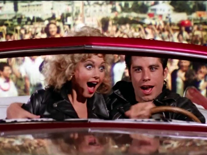 sandy and danny flying away from the carnival in a car