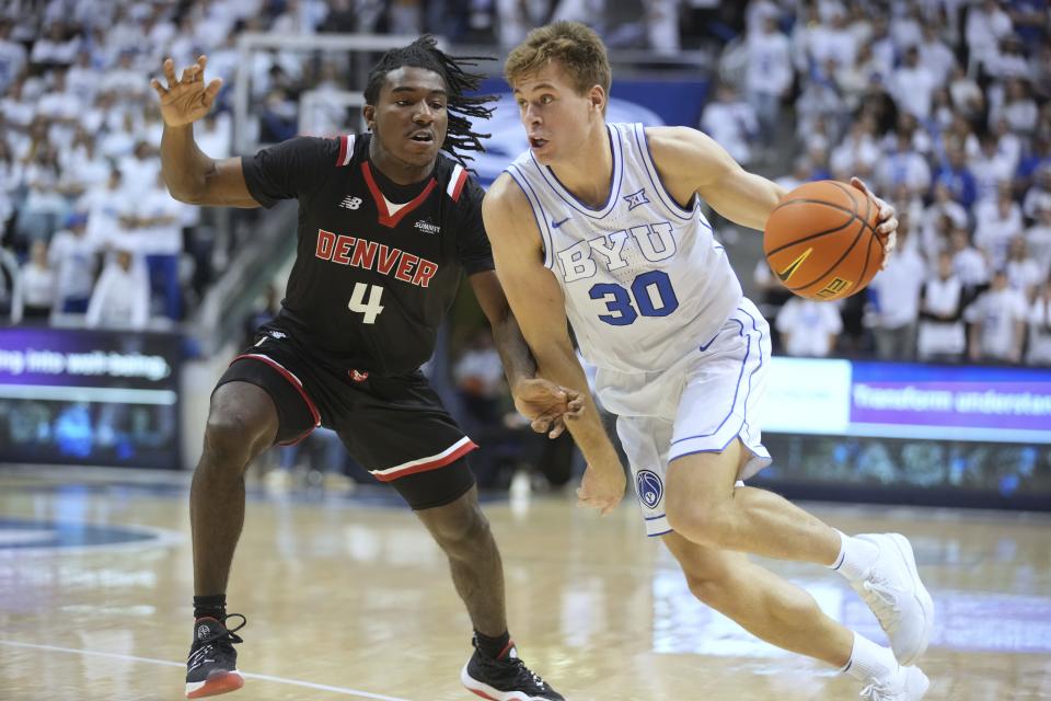 BYU guard Dallin Hall drives past Denver guard DeAndre Craig during game Wednesday, Dec. 13, 2023, in Provo, Utah. | George Frey, Associated Press