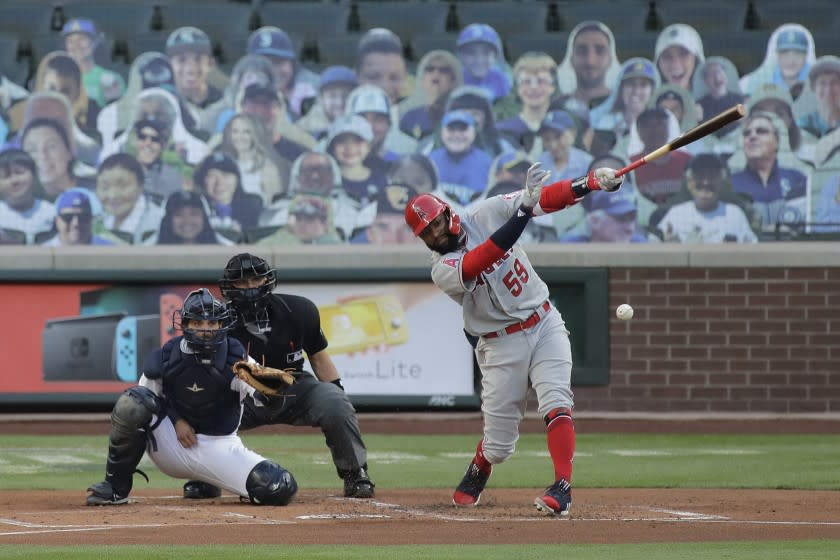 Los Angeles Angels' Jo Adell (59) hits a single in his first major-league at-bat during the first inning of a baseball game against the Seattle Mariners, Tuesday, Aug. 4, 2020, in Seattle. (AP Photo/Ted S. Warren)