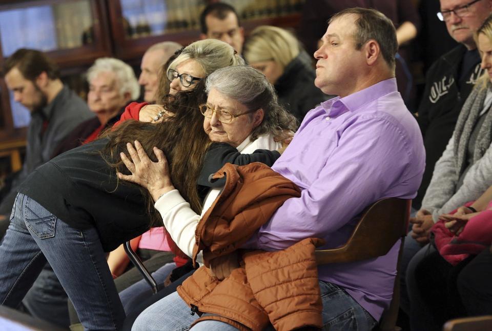 FILE - This Tuesday, Nov. 27, 2018 file photo shows Geneva Rhoden comforted while awaiting the arraignment proceedings for Edward "Jake" Wagner at the Pike County Courthouse on in Waverly, Ohio. A man who lost several relatives in the killings of eight people in southern Ohio four years ago filed a wrongful death lawsuit Tuesday, Nov. 10, 2020 against the suspects, saying he wants to be sure none of them receive financial gain from the crime. (Brooke LaValley/The Columbus Dispatch via AP, File)