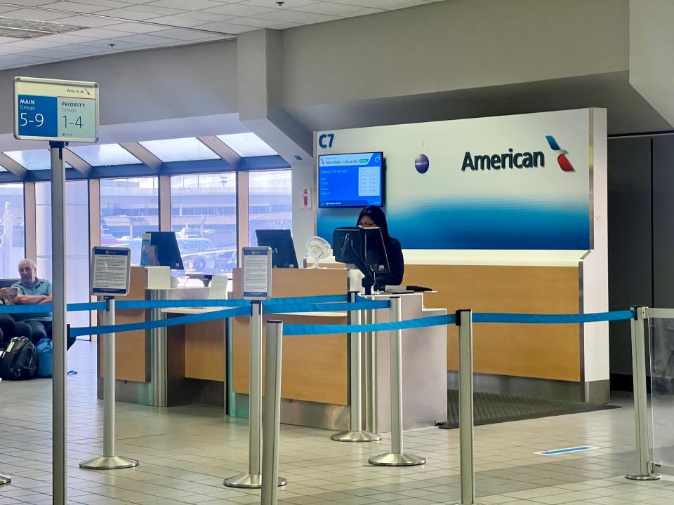 Gate C7 at DFW airport with an agent a the counter.