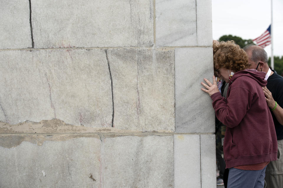 Followers of Franklin Graham pray at the base of the Washington Monument as they march from the Lincoln Memorial to Capitol Hill, during the Prayer March at the National Mall, in Washington, Saturday, Sept. 26, 2020. (AP Photo/Jose Luis Magana)