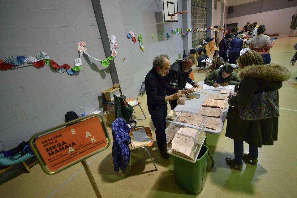 Election officials count votes at a polling station for the general election, in Pamplona, northern Spain, Sunday, Nov. 10, 2019. As Spaniards voted Sunday in the country’s fourth election in as many years, a leading leftist party pledged to help the incumbent Socialists in hopes of staving off a possible right-wing coalition government that could include a far-right party. (AP Photo/Alvaro Barrientos)
