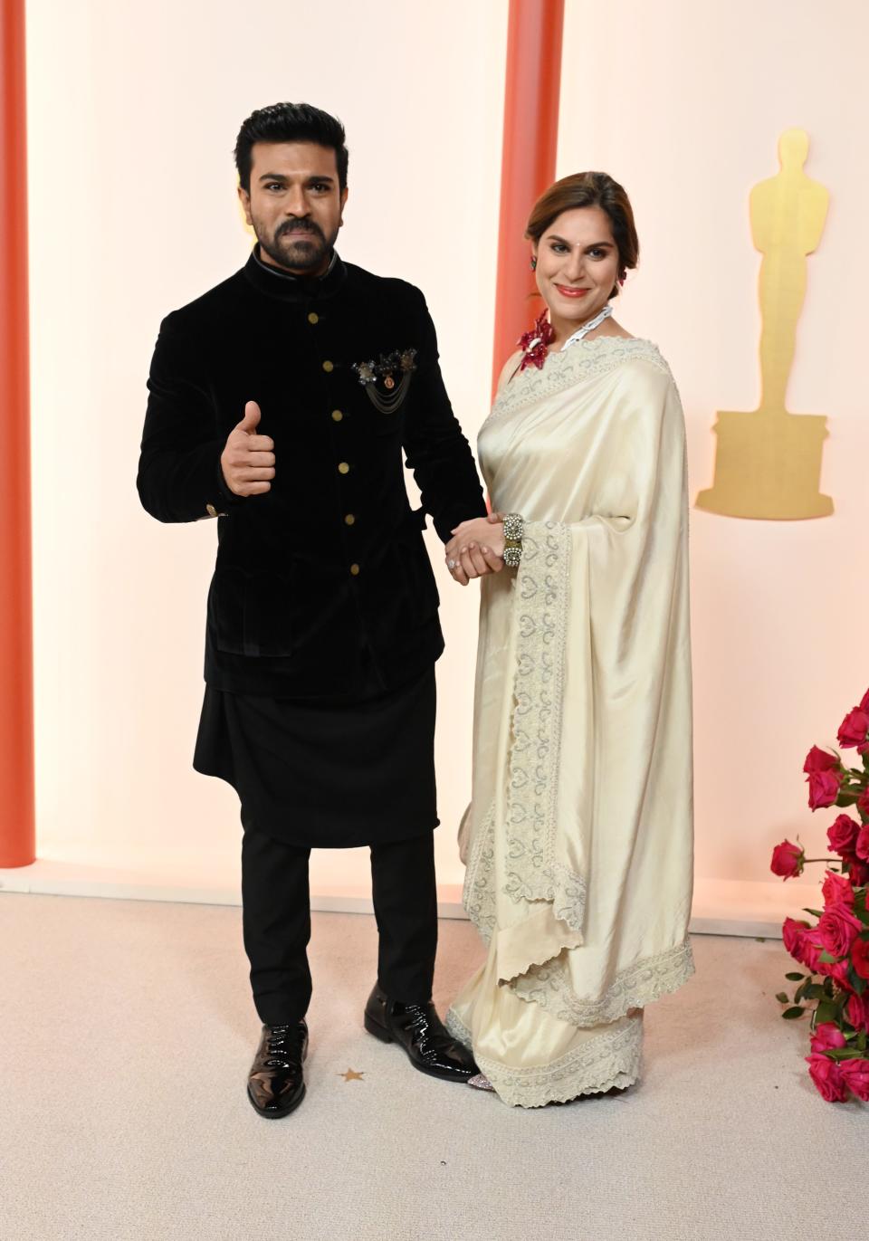 Ram Charan and Upasana Kamineni attend the 2023 Academy Awards.