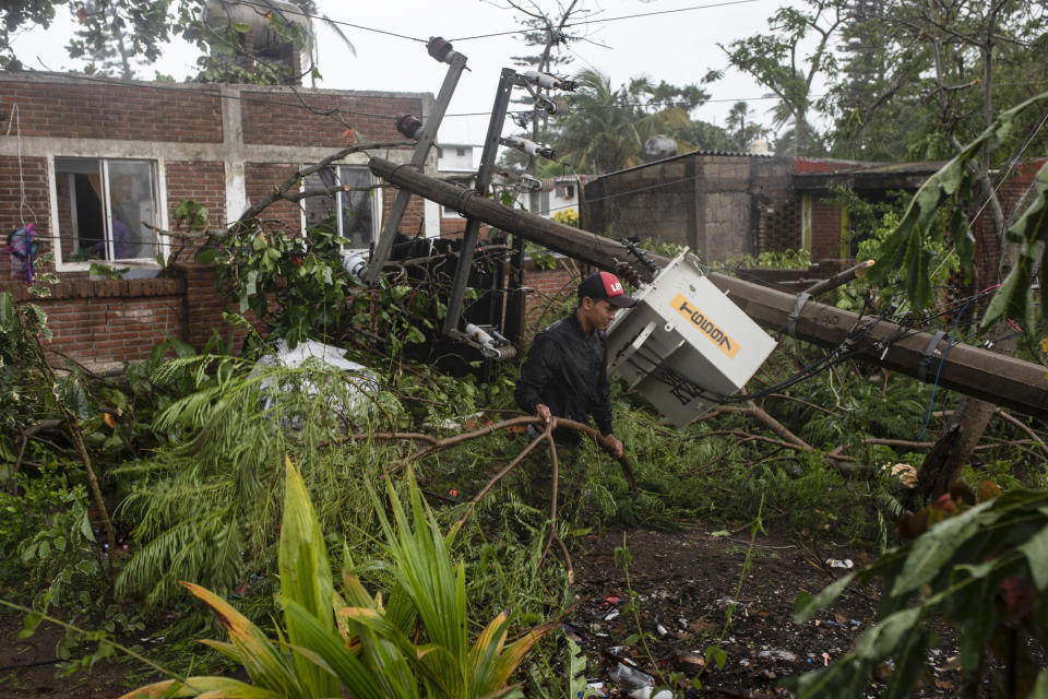 A man inspects the damage after part of his home was toppled by winds brought on by Hurricane Grace, in Tecolutla, Veracruz State, Mexico, Saturday, Aug. 21, 2021. Grace hit Mexico’s Gulf shore as a major Category 3 storm before weakening on Saturday, drenching coastal and inland areas in its second landfall in the country in two days. (AP Photo/Felix Marquez)