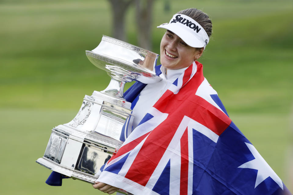 Hannah Green, of Australia, holds the trophy after winning the KPMG Women's PGA Championship golf tournament, Sunday, June 23, 2019, in Chaska, Minn. (AP Photo/Charlie Neibergall)