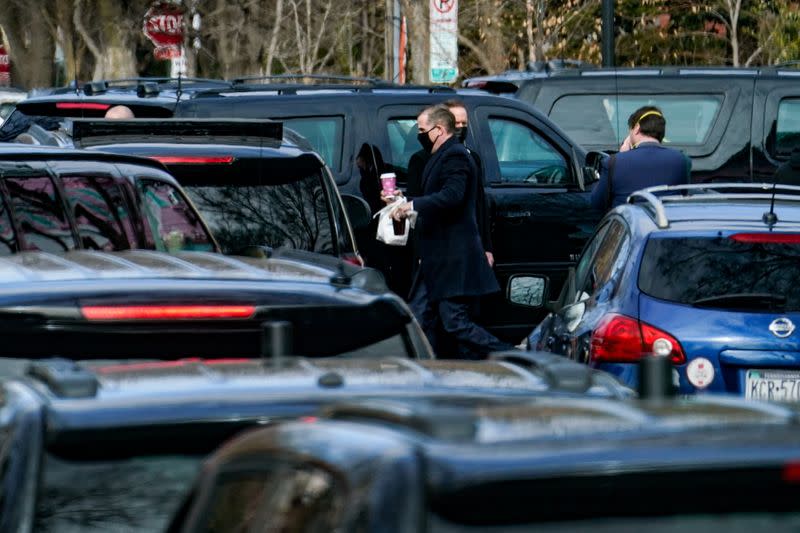 Hunter Biden, son of U.S. President Joe Biden, carries bagels to the presidential motorcade after a visit to Holy Trinity Catholic Church in Washington