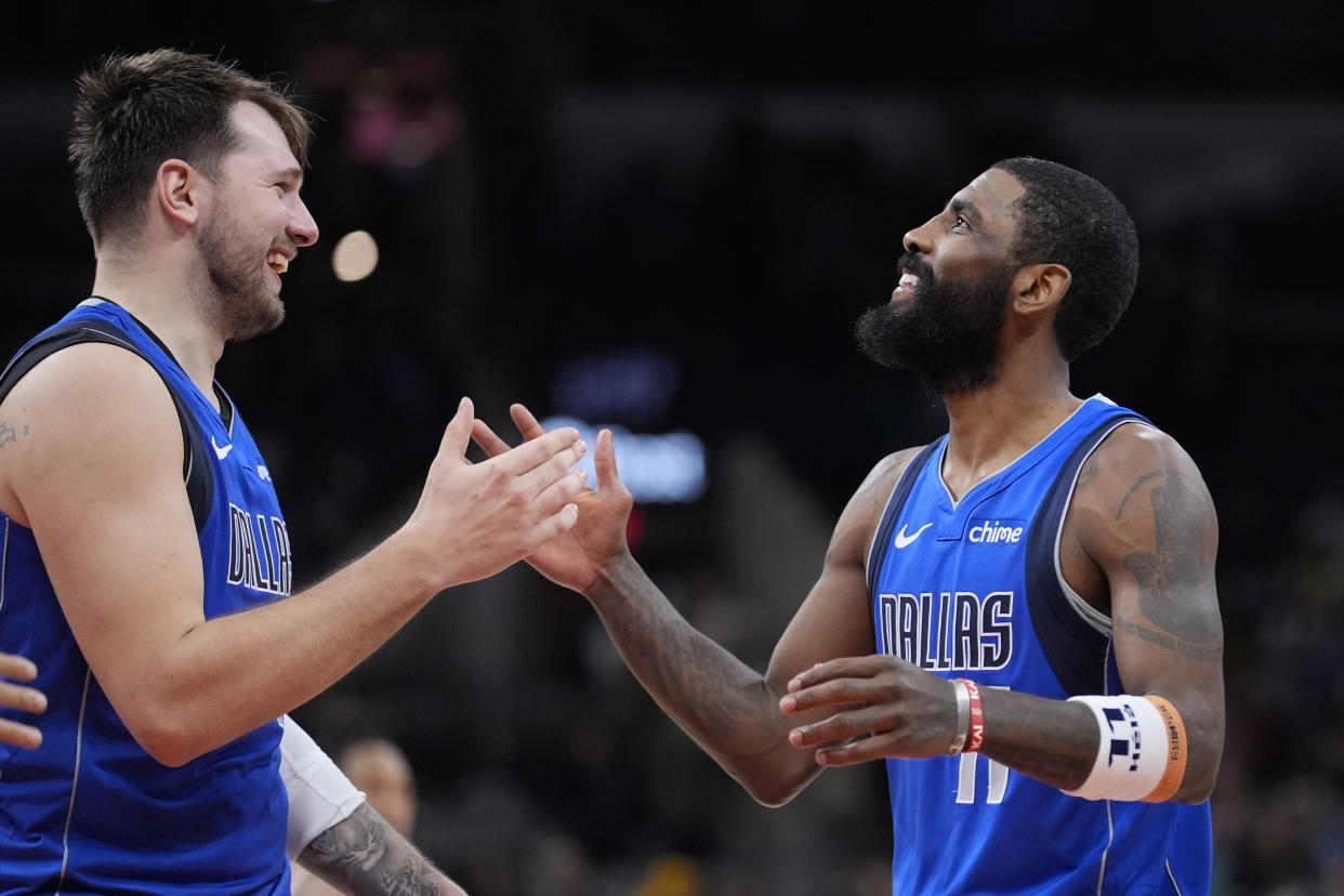 Dallas Mavericks guard Luka Doncic, left, and Dallas Mavericks guard Kyrie Irving, right, celebrate their win over the San Antonio Spurs in an NBA basketball game in San Antonio, Tuesday, March 19, 2024. (AP Photo/Eric Gay)