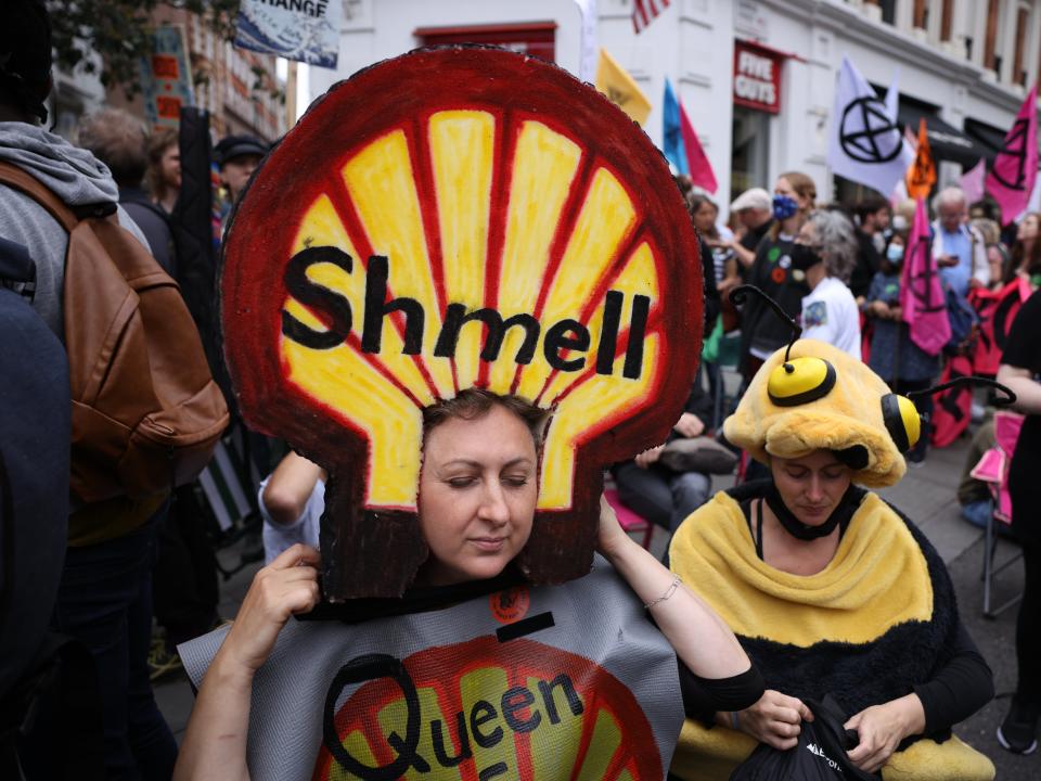 Protesters dressed in costumes gather beneath XR’s crisis-talks table (Getty)