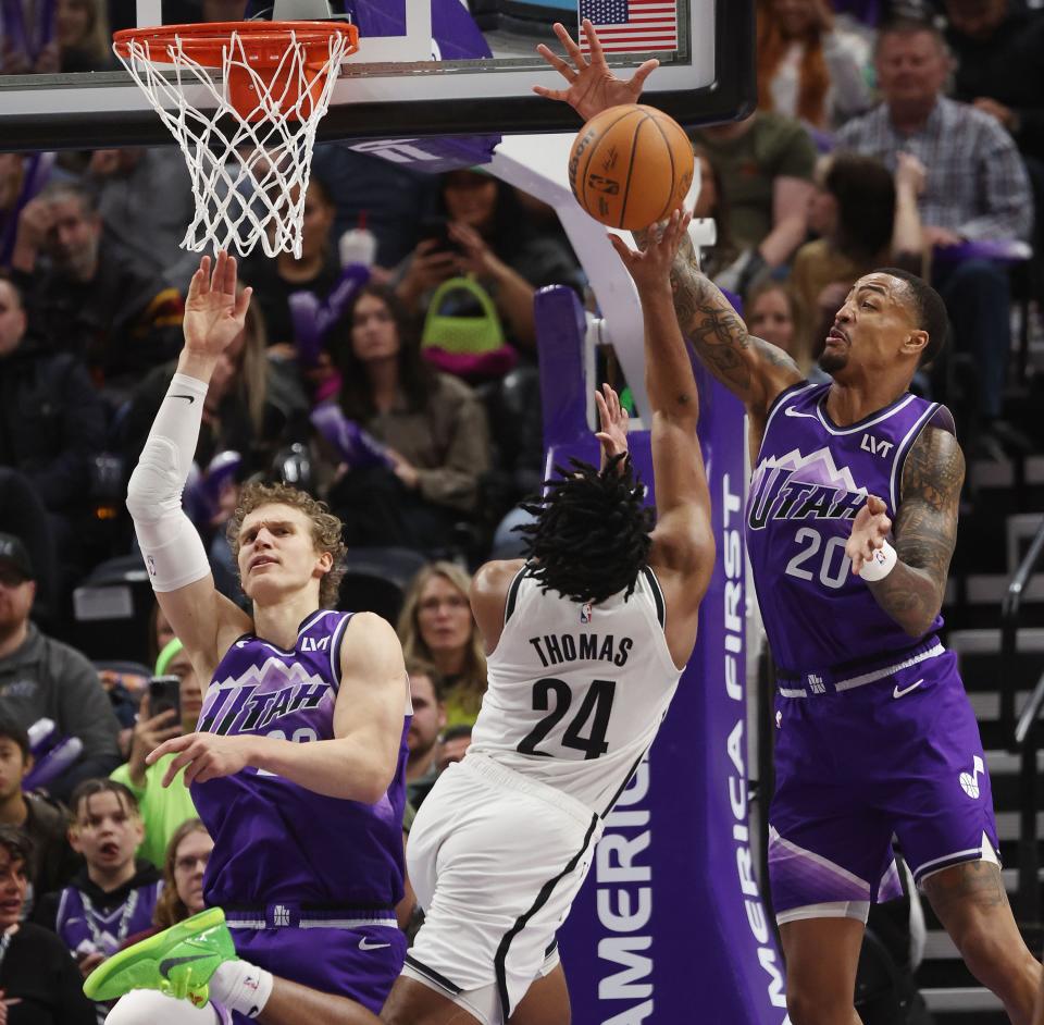 Utah Jazz forward John Collins (20) and Utah Jazz forward Lauri Markkanen (23) defend Brooklyn Nets guard Cam Thomas (24) in Salt Lake City on Monday, Dec. 18, 2023. The Jazz won 125-108. | Jeffrey D. Allred, Deseret News