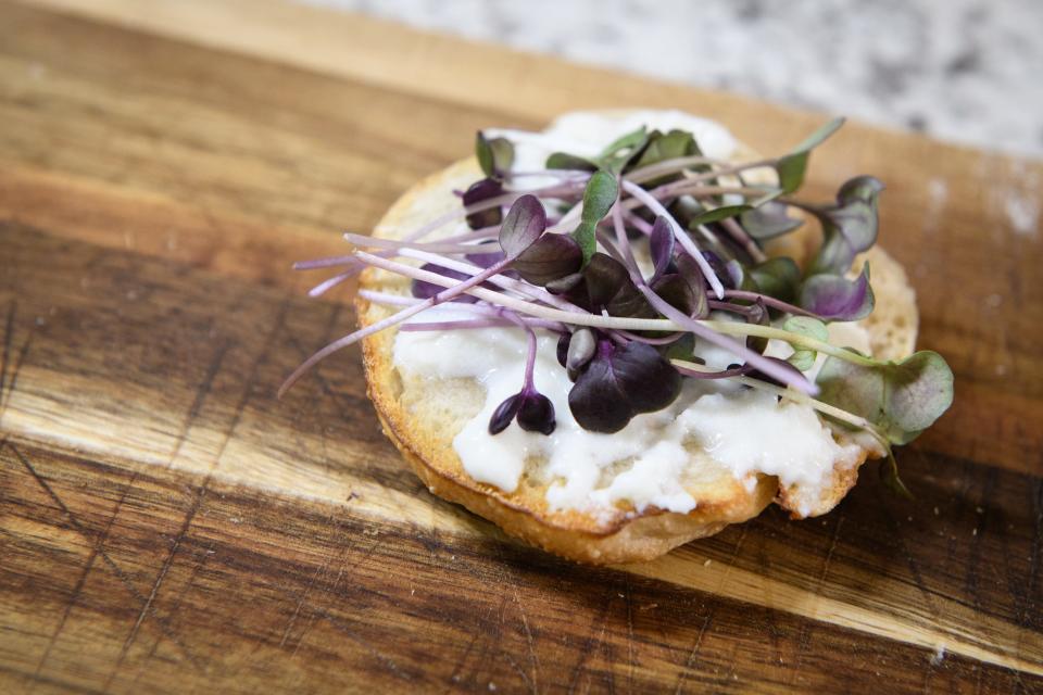 A sourdough bagel with goat cheese and radish micro greens at the Rye Family Farm in Sanford. 