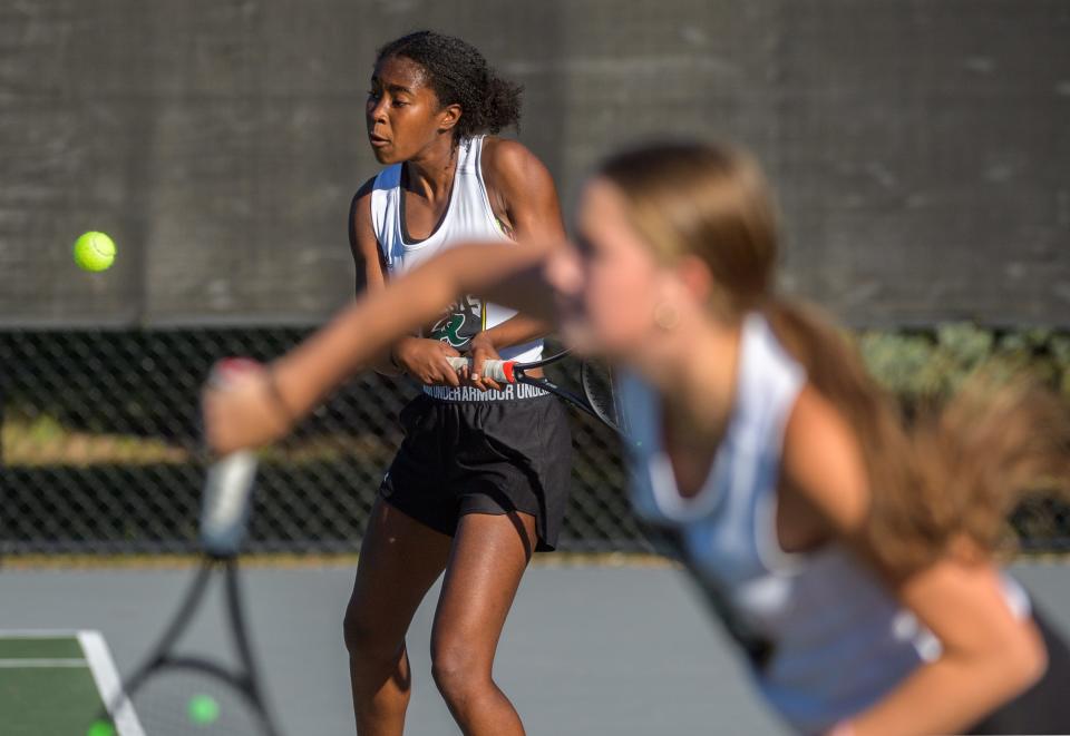 Richwoods sophomore Olivia Reynolds, background, and junior Julia Wojtowicz play side-by-side on Sept. 29, 2022 against Bloomington High School on the Richwoods tennis courts.