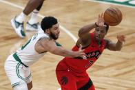 Toronto Raptors' Kyle Lowry (7) passes off as Boston Celtics' Jayson Tatum (0) defends during the second half of an NBA basketball game, Thursday, Feb. 11, 2021, in Boston. (AP Photo/Michael Dwyer)