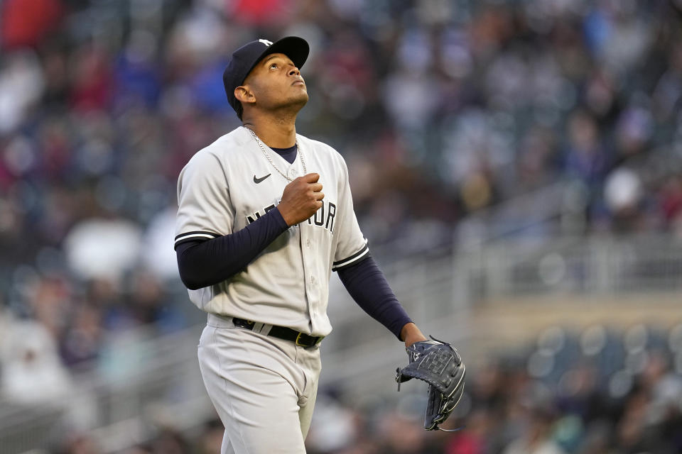 New York Yankees starting pitcher Jhony Brito walks back to the dugout after being pulled from the game during the third inning of a baseball game against the Minnesota Twins, Monday, April 24, 2023, in Minneapolis. (AP Photo/Abbie Parr)