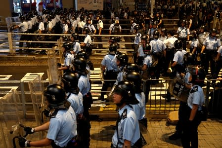 Riot police stand guard after clearing the area outside the police headquarters after a rally ahead of the G20 summit, in Hong Kong