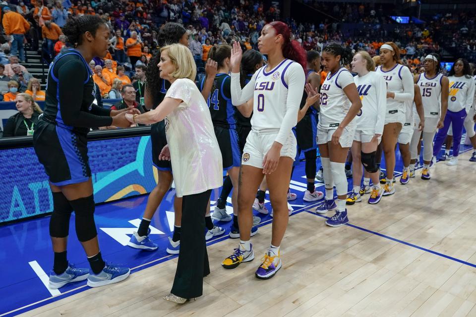 LSU head coach Kim Mulkey and her team congratulate Kentucky players after an NCAA college basketball game at the women's Southeastern Conference tournament Friday, March 4, 2022, in Nashville, Tenn. Kentucky won 78-63. (AP Photo/Mark Humphrey)
