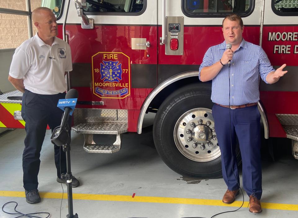 Mooresville Town Councilman Dustin Stanley, right, discusses the recent surrender of a baby girl at Mooresville's Safe Haven Baby Box.