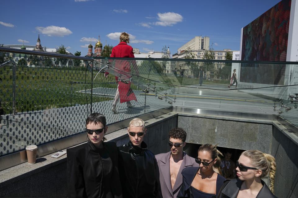 Models gather backstage waiting for their turn to display a collection by graduates of the British Higher School of Art & Design during the Fashion Week at Zaryadye Park near Red Square in Moscow, Russia, Friday, June 24, 2022. (AP Photo/Alexander Zemlianichenko)