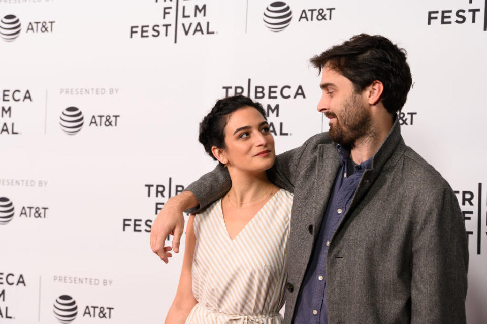 Jenny and Ben on the red carpet, the former is looking up at the latter while he has his arm on her shoulder