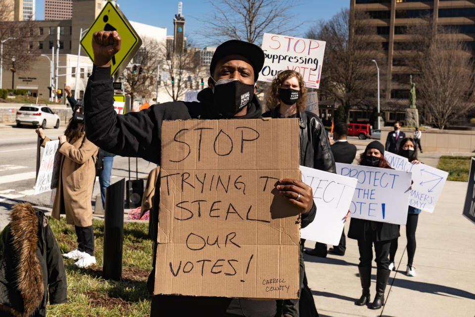 Demonstrators stand outside of the Georgia Capitol building