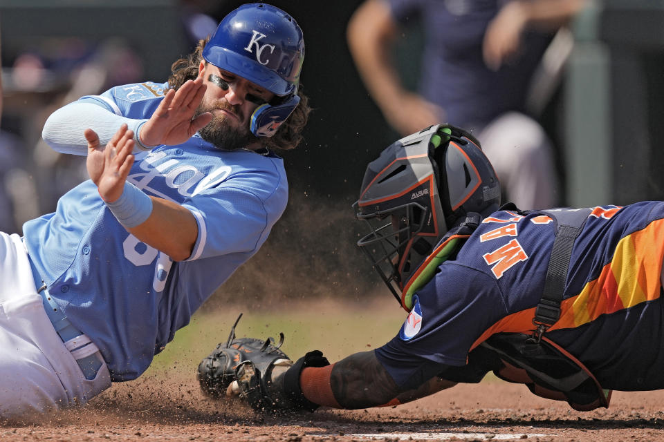 Kansas City Royals' Logan Porter, left, is tagged out at home by Houston Astros catcher Martin Maldonado as he tried to score on a single by Maikel Garcia during the fifth inning of a baseball game Sunday, Sept. 17, 2023, in Kansas City, Mo. (AP Photo/Charlie Riedel)