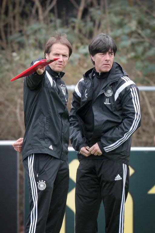 Germany's head coach Joachim Loew (R) and assistant coach Thomas Schneider talk during a team training session in Frankfurt am Main, on March 27, 2015 ahead of their UEFA Euro 2016 qualifying football match against Georgia