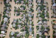 An aerial view of suburban streets flooded in Longmont, Colorado September 13, 2013. National Guard troops plucked stranded residents out of danger by helicopter and hauled them out of an inundated community in military trucks Friday, as the death toll from the worst floods to hit Colorado in decades rose to four with 80 people still unaccounted for. REUTERS/John Wark (UNITED STATES - Tags: ENVIRONMENT DISASTER)