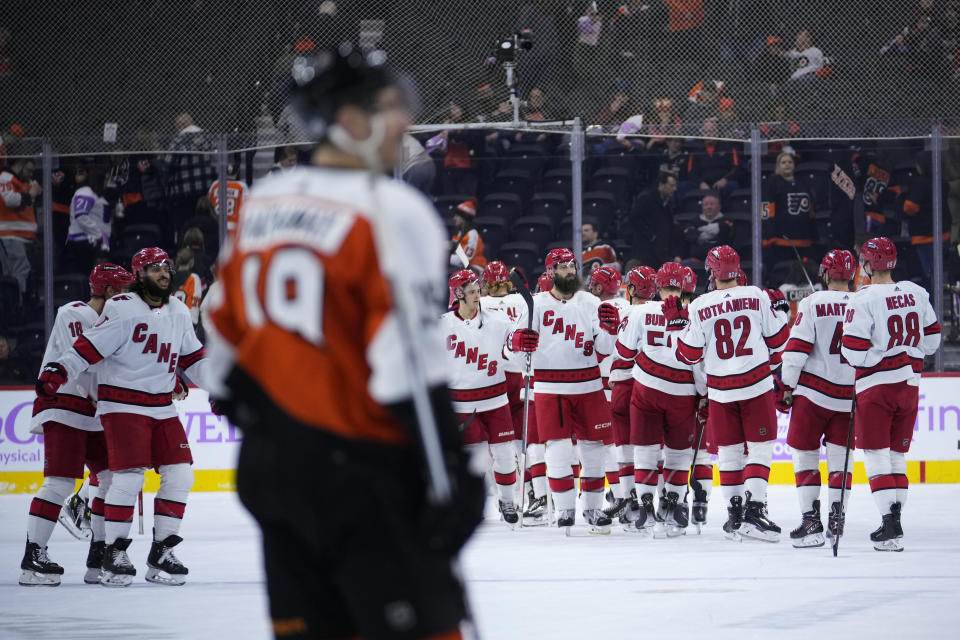 Carolina Hurricanes' players celebrate after winning an NHL hockey game against the Philadelphia Flyers, Tuesday, Nov. 28, 2023, in Philadelphia. (AP Photo/Matt Slocum)