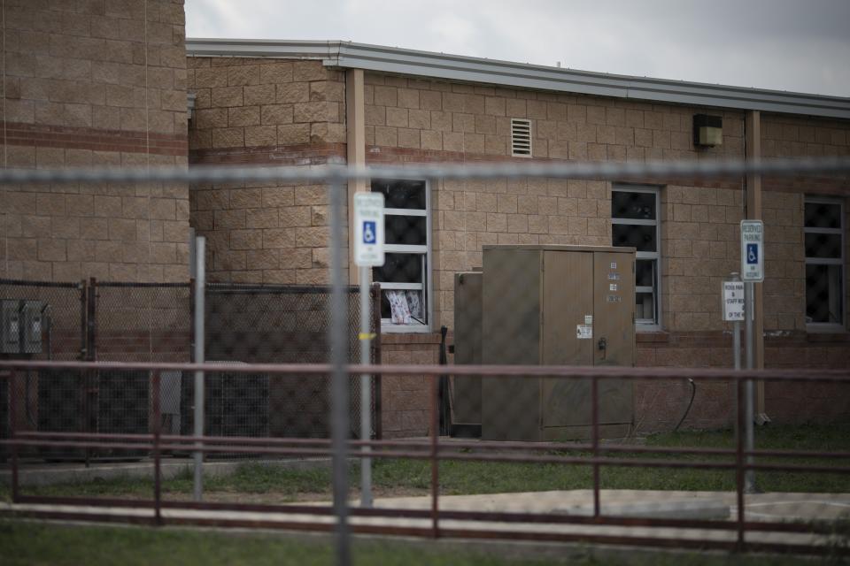 A curtain blows in an open window of Robb Elementary School in Uvalde, Texas, Monday, May 30, 2022. On May 24, 2022, an 18-year-old entered the school and fatally shot several children and teachers. (AP Photo/Wong Maye-E)