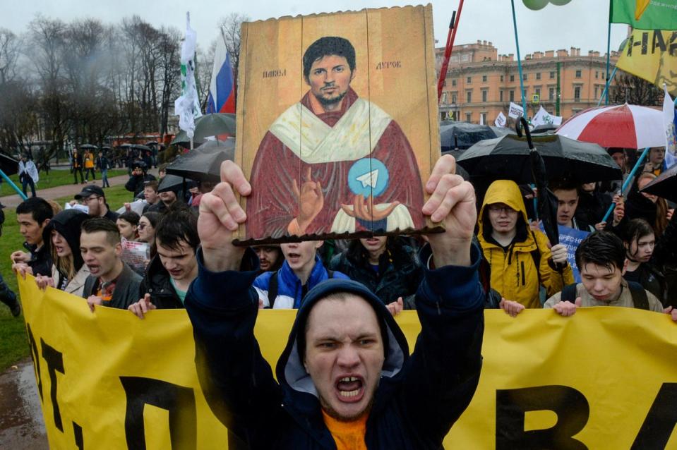 Demonstrators with a icon stylised painting depicting Telegram's founder Pavel Durov  protest against the blocking of the popular messaging app in Russia, during a May Day rally in Saint Petersburg on 1 May, 2018 (AFP via Getty Images)