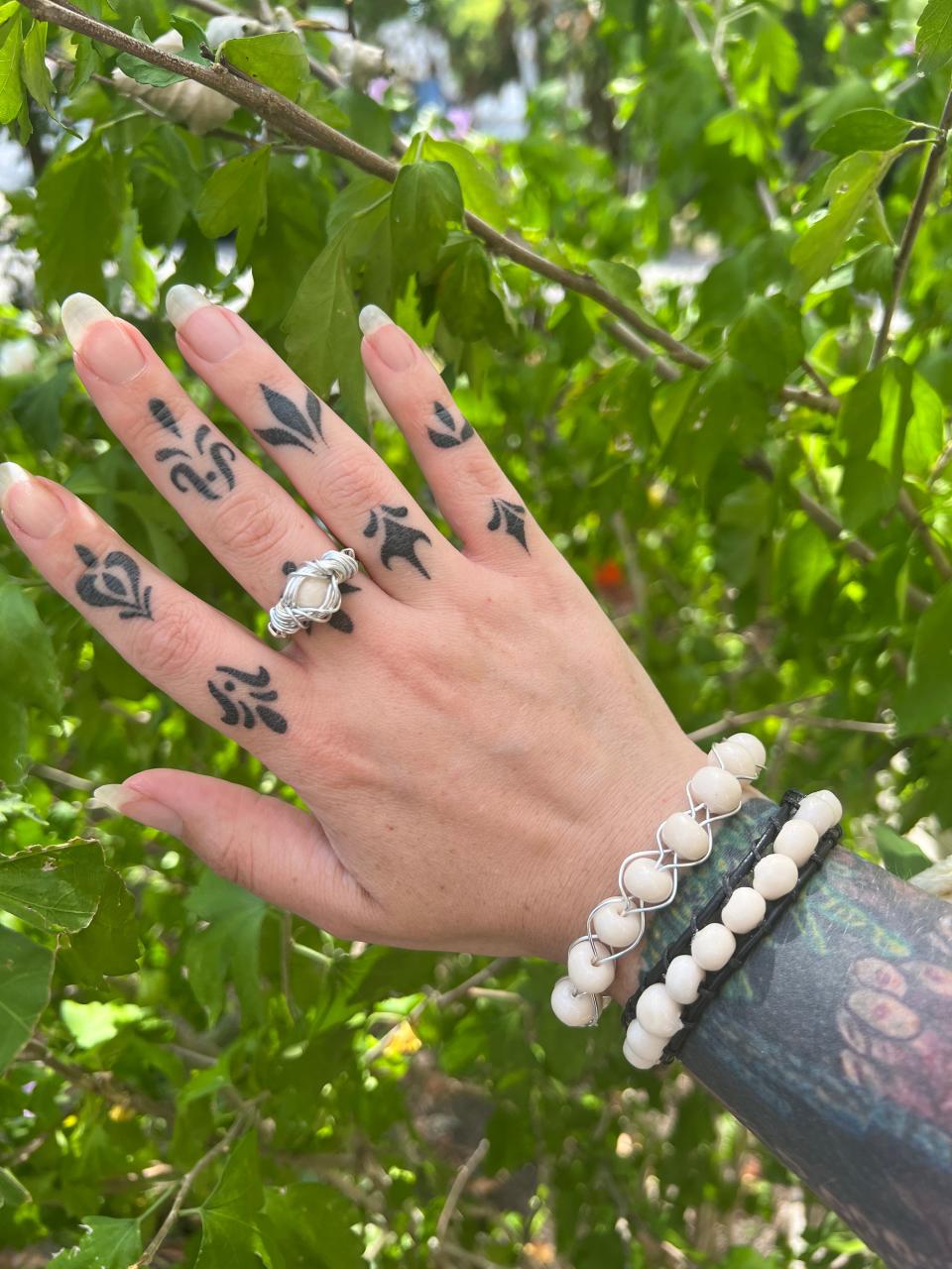 Amanda Booth wearing a ring and two bracelets from her Jizzy Jewelry collection