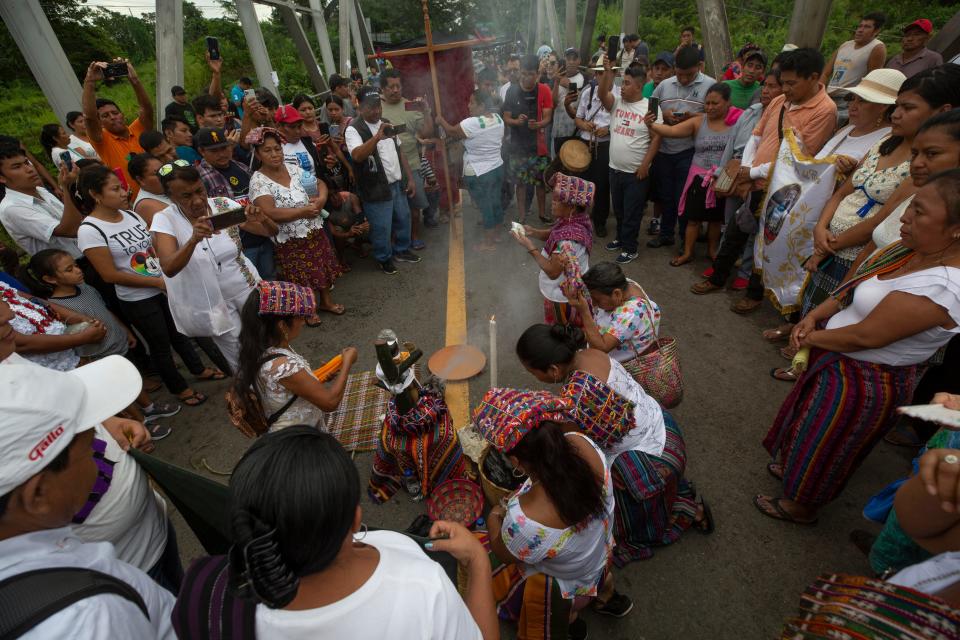 Indigenous women from San Sebastian perform a ritual on the Castillo de Armas bridge where a blockade was set as part of a national protest in Guatemala on Oct. 8, 2023.