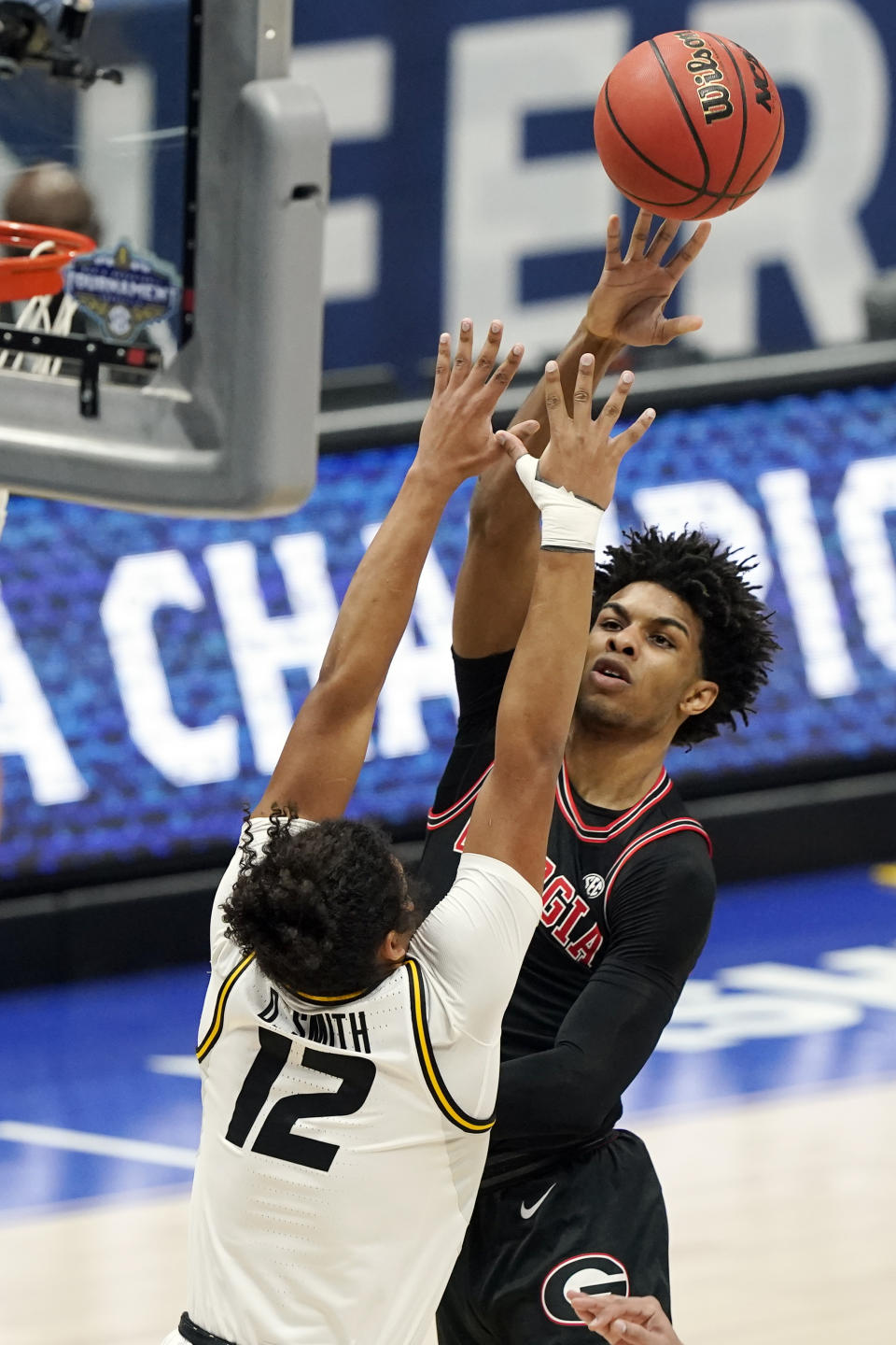 Georgia's Justin Kier shoots against Missouri's Dru Smith (12) in the first half of an NCAA college basketball game in the Southeastern Conference Tournament Thursday, March 11, 2021, in Nashville, Tenn. (AP Photo/Mark Humphrey)