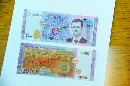 A portrait of Syria's President Bashar al-Assad is seen printed on the new Syrian 2,000-pound banknote that went into circulation on Sunday, in this handout picture provided by SANA on July 2, 2017, Syria. SANA/Handout via REUTERS