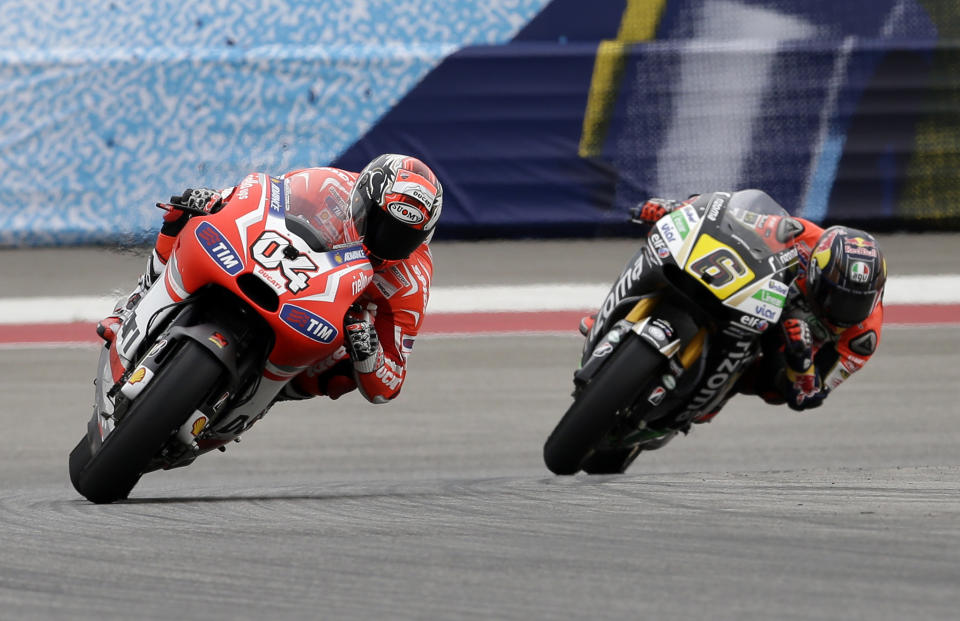 Andrea Dovizioso of Italy leads Stefan Bradl (6) of Germany out of Turn 5 during the Grand Prix of the Americas MotoGP motorcycle race, Sunday, April 13, 2014, in Austin, Texas. Dovizioso finished third in the race. (AP Photo/Tony Gutierrez)