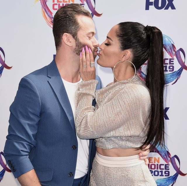 Nikki Bella and boyfriend Artem Chigvintsev kiss on red carpet