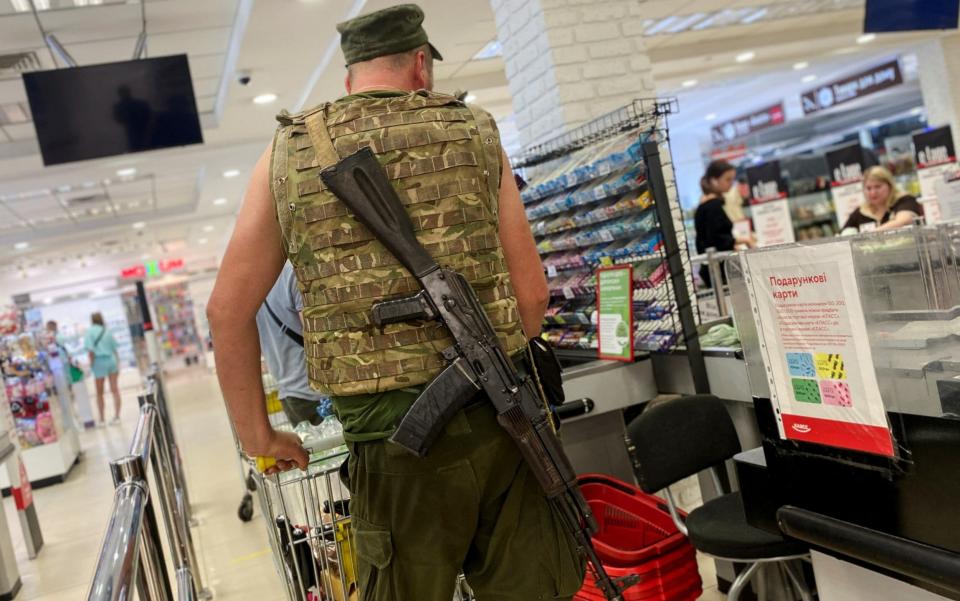 A Ukrainian serviceman pushes a trolley at a supermarket in Kharkiv, as Russia's invasion of Ukraine continues - REUTERS/Nacho Doce