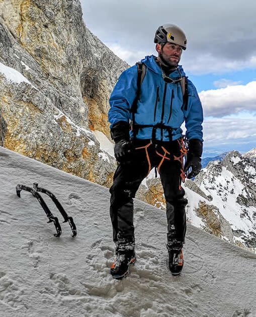 Badriashvili with helmet, climbing harness and crampons, on an icy ramp
