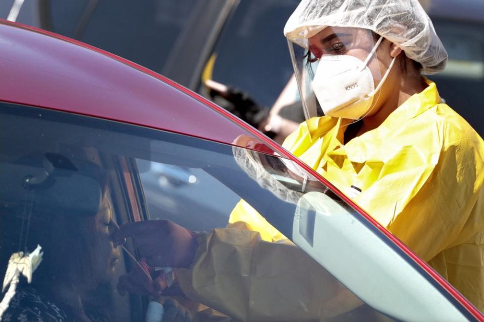 People get tested for COVID-19 at a drive through testing site hosted by the Puente Movement migrant justice organisation in Phoenix. Source: AP