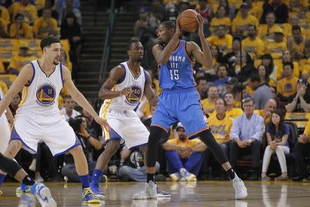 May 26, 2016; Oakland, CA, USA; Oklahoma City Thunder forward Kevin Durant (35) holds onto the ball as Golden State Warriors forward Harrison Barnes (40) defends in the first quarter in game five of the Western conference finals of the NBA Playoffs at Oracle Arena. Mandatory Credit: Cary Edmondson-USA TODAY Sports