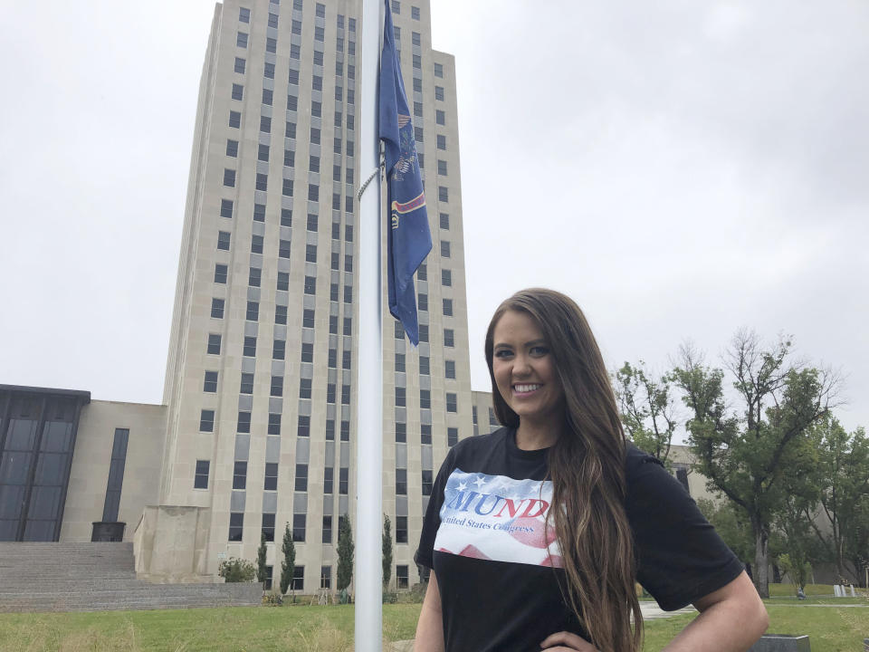 Former Miss America Cara Mund poses in front of the North Dakota state Capitol in Bismarck, N.D., Saturday, Sept. 17, 2022. Mund is running as an independent candidate for North Dakota’s lone U.S. House seat. (AP Photo/James MacPherson)